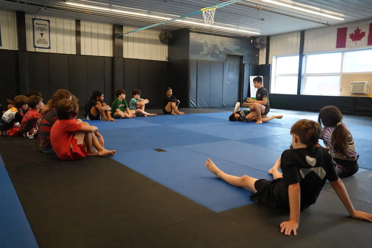 Full group of kids and teens seated for the training brief
