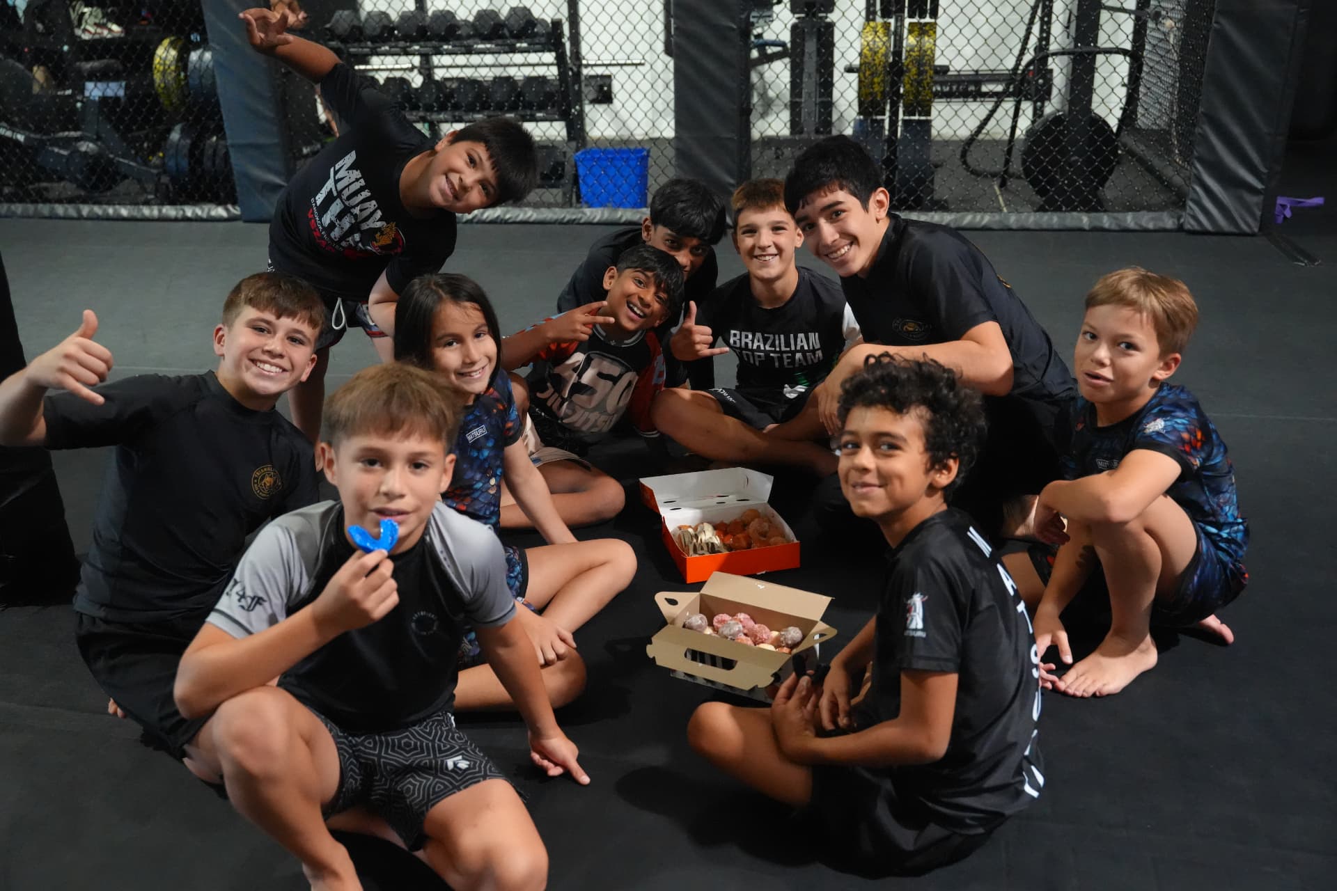 Camp kids enjoying a snack break together on the mats at Triangle Nation in Laval