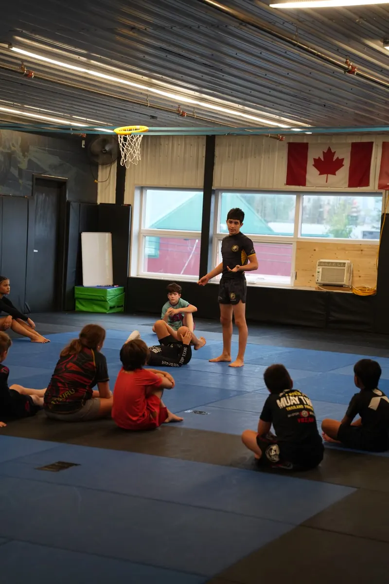 Jayden Portillo explaining a competition scoring detail to the group