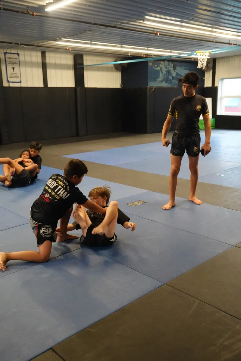 Jayden Portillo supervising positional rounds on the mats